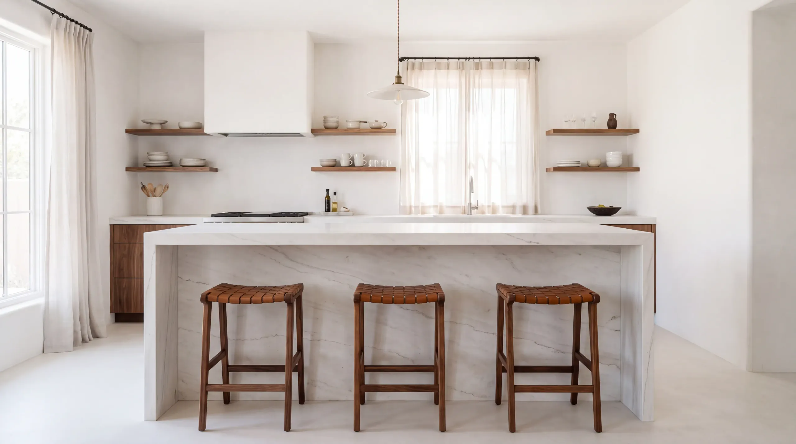 A white kitchen with a honed dolomite island