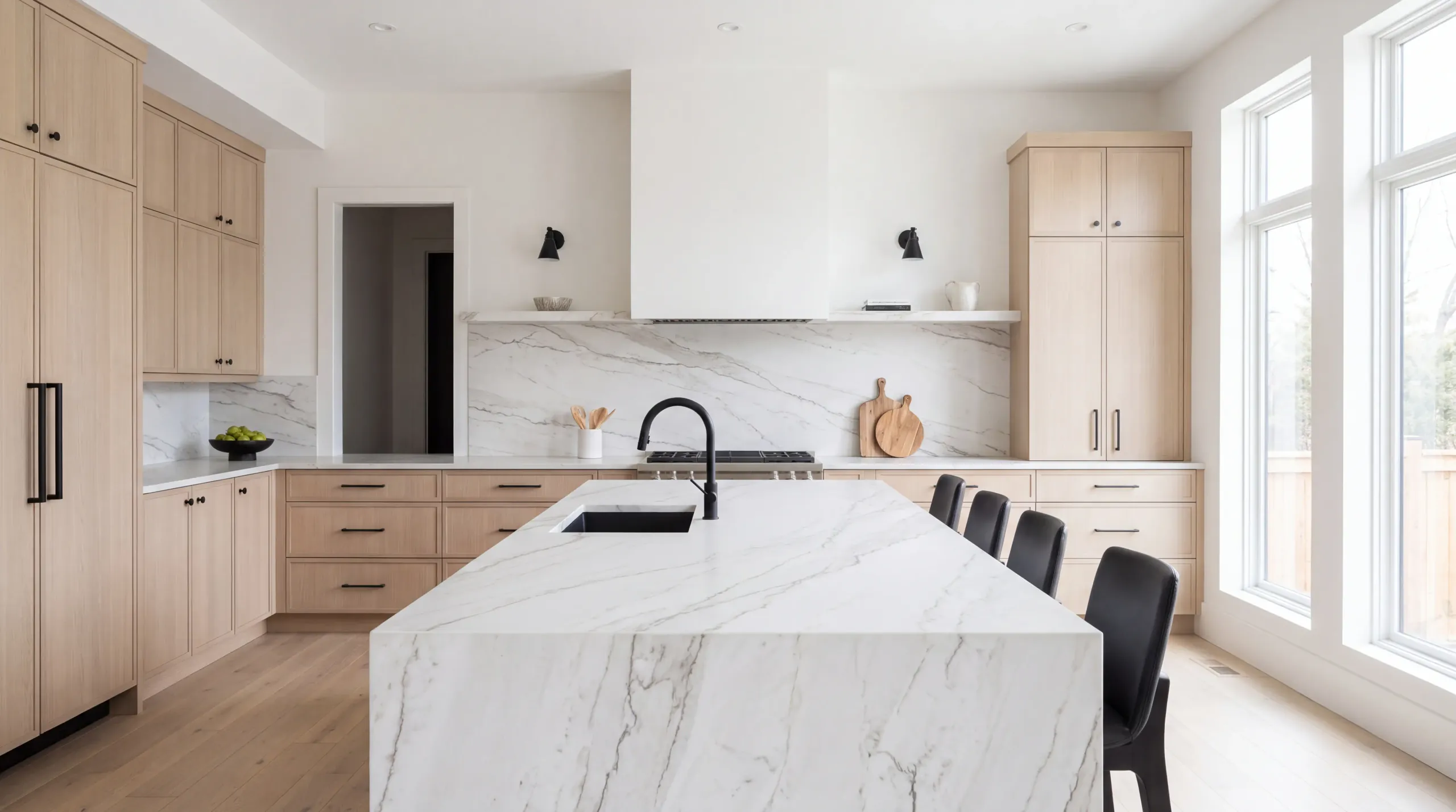 A bright kitchen with a long island and backsplash in white quartzite