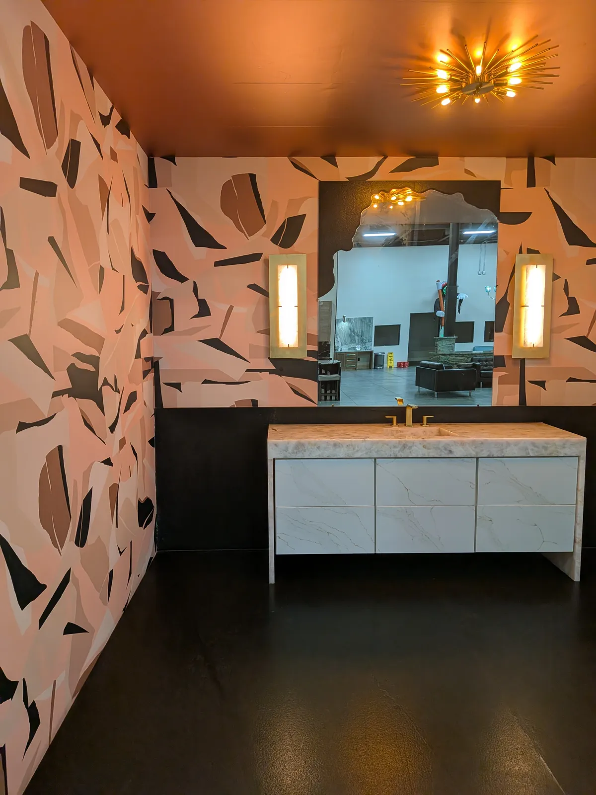 A powder room with patterned stone walls and a white vanity