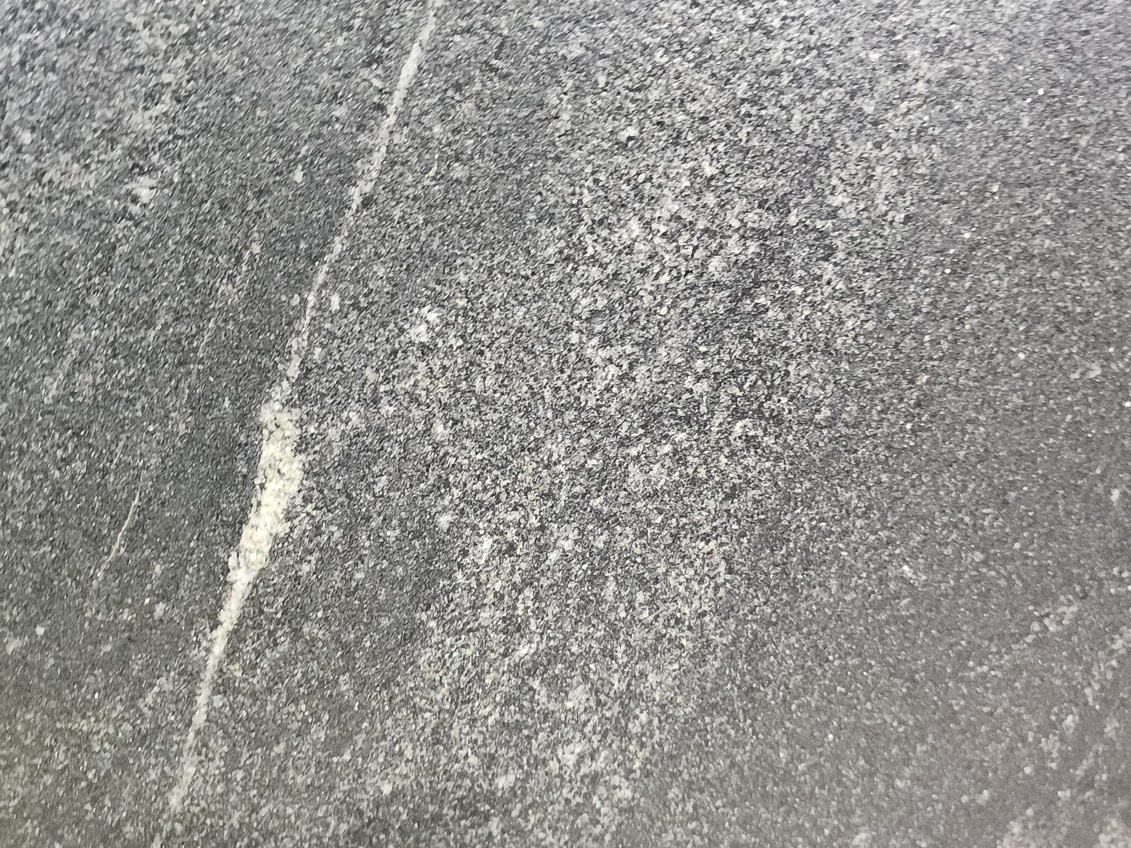 Black Mist Leather, a granite slab, at KLZ Stone Supply in Dallas