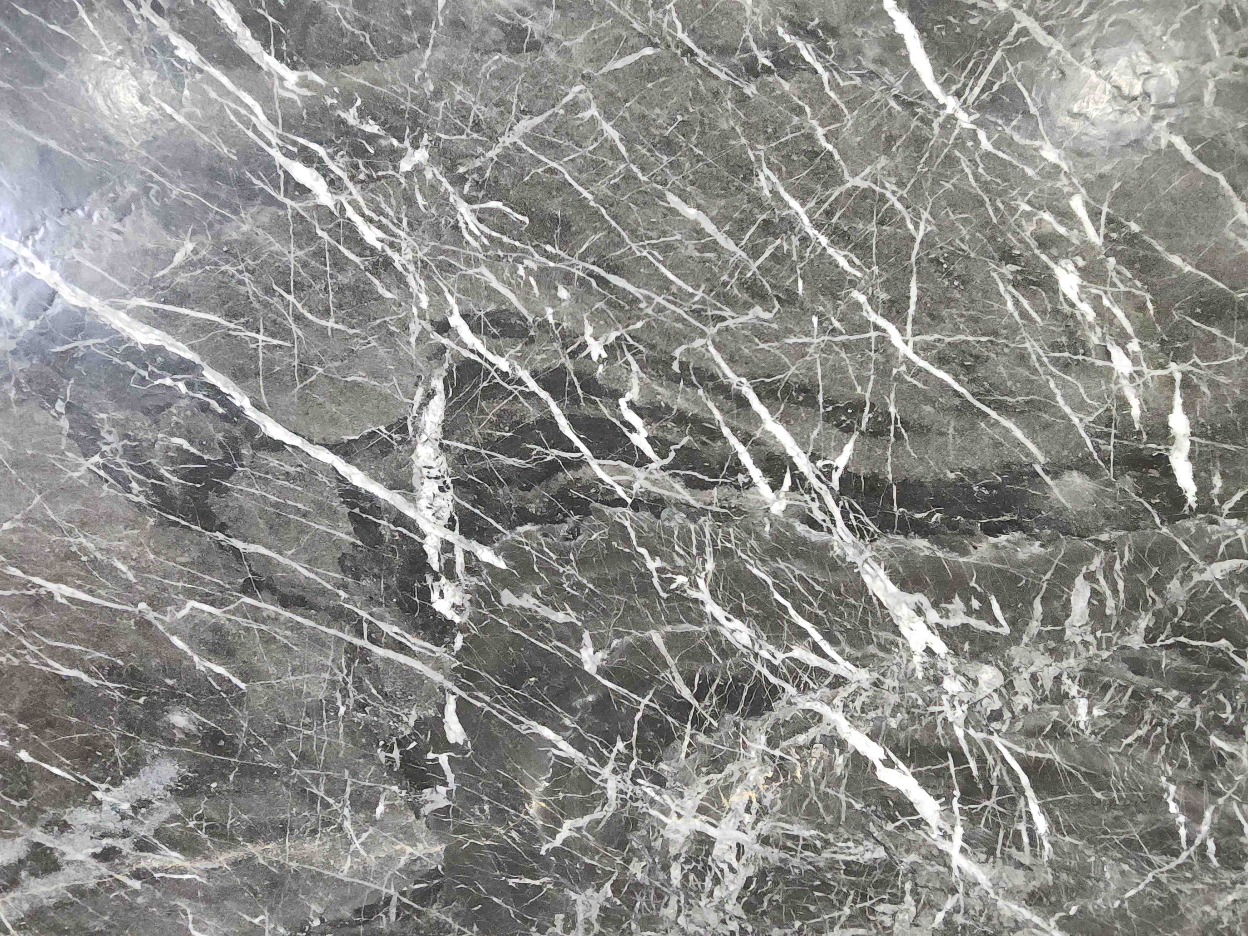 Dom Nero Leather, a marble slab, at KLZ Stone Supply in Dallas