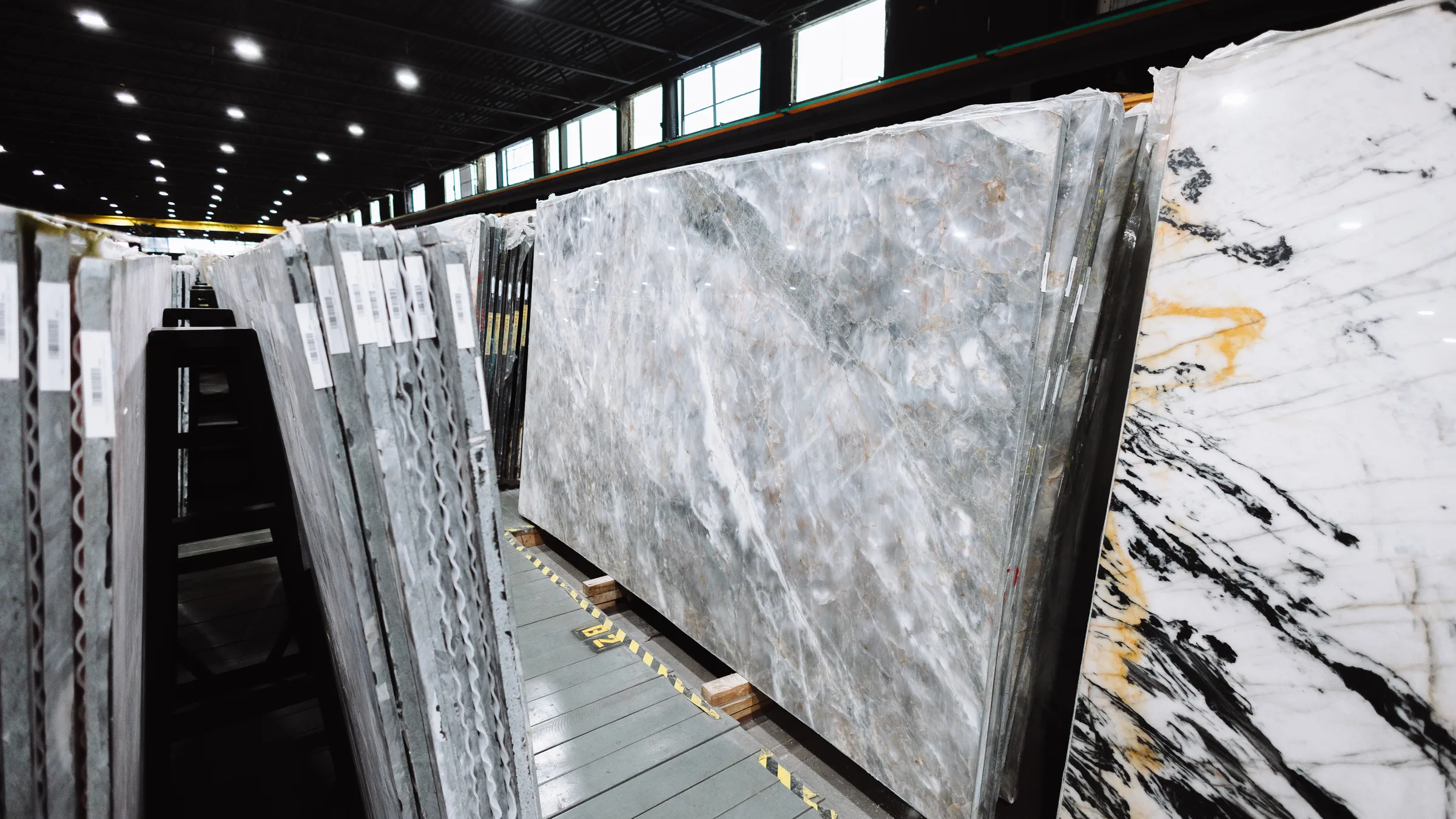Slabs racked by bundle down an aisle of the KLZ warehouse